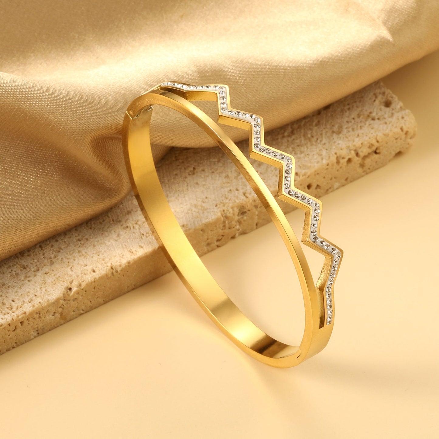 wavy, diamond-studded hard bracelet like a crown
