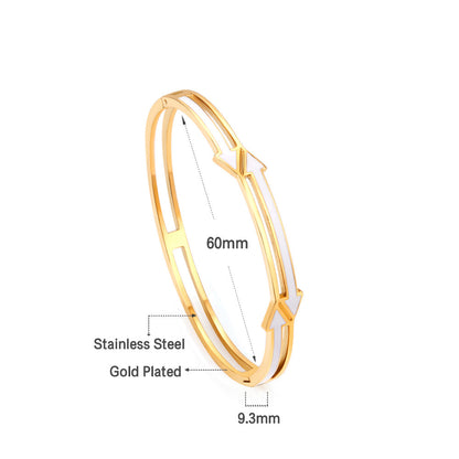 Gold colored hard bracelet with directional arrows