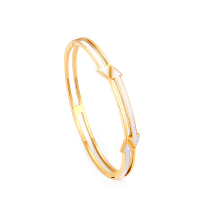Gold colored hard bracelet with directional arrows