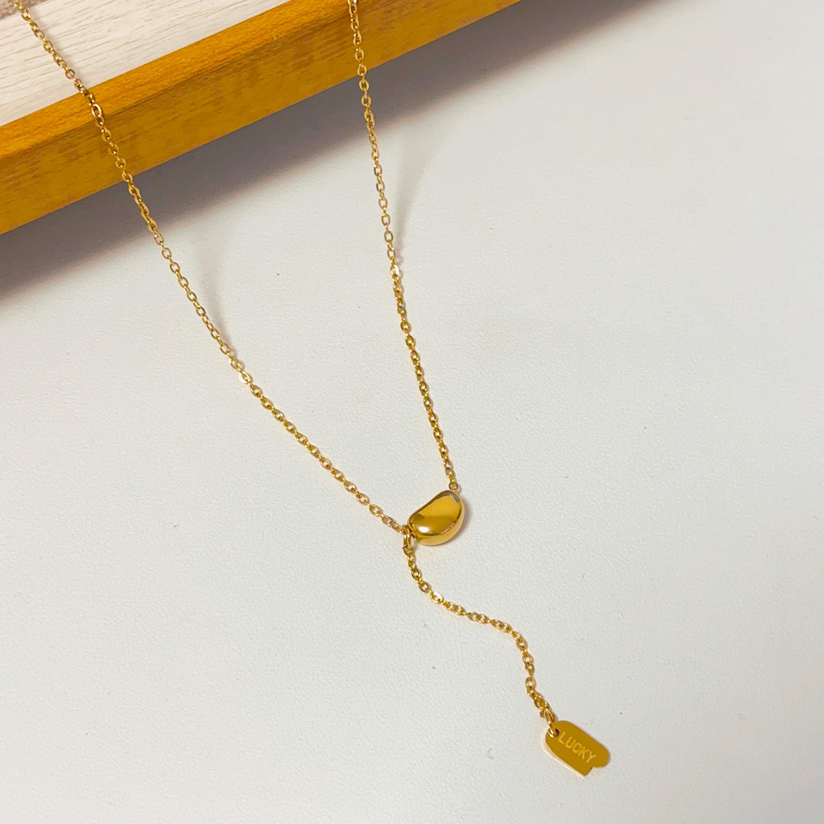 bean pendant with charm